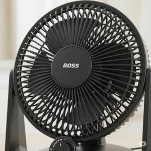 Close-up of a compact Boss desk fan, perfect for personal cooling in a home or office environment.