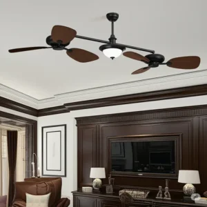A dual ceiling fan with an oil-rubbed bronze finish and dark wood blades installed in a classic-style room with dark wood paneling.