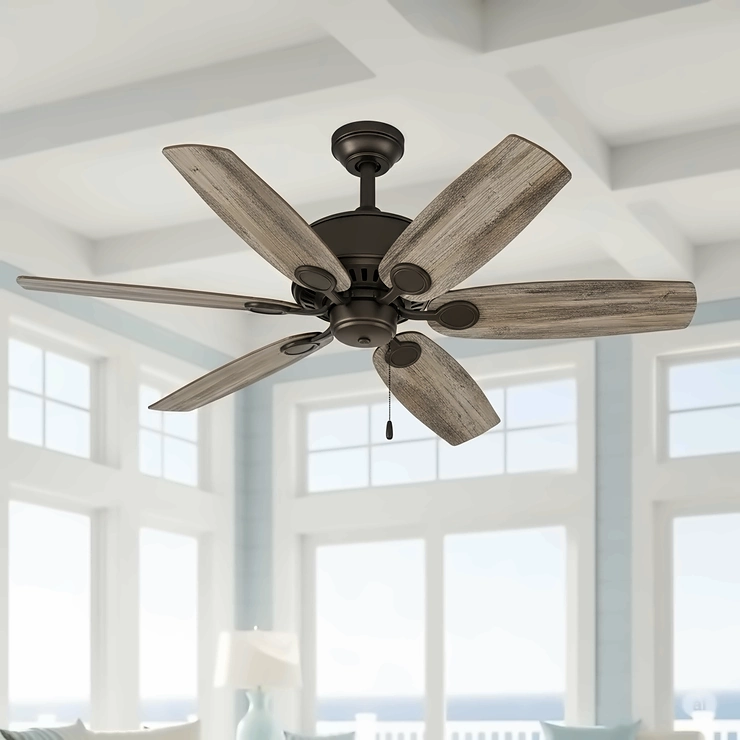 A coastal ceiling fan featuring distressed or weathered wood-look blades, evoking a rustic, beach-worn aesthetic.