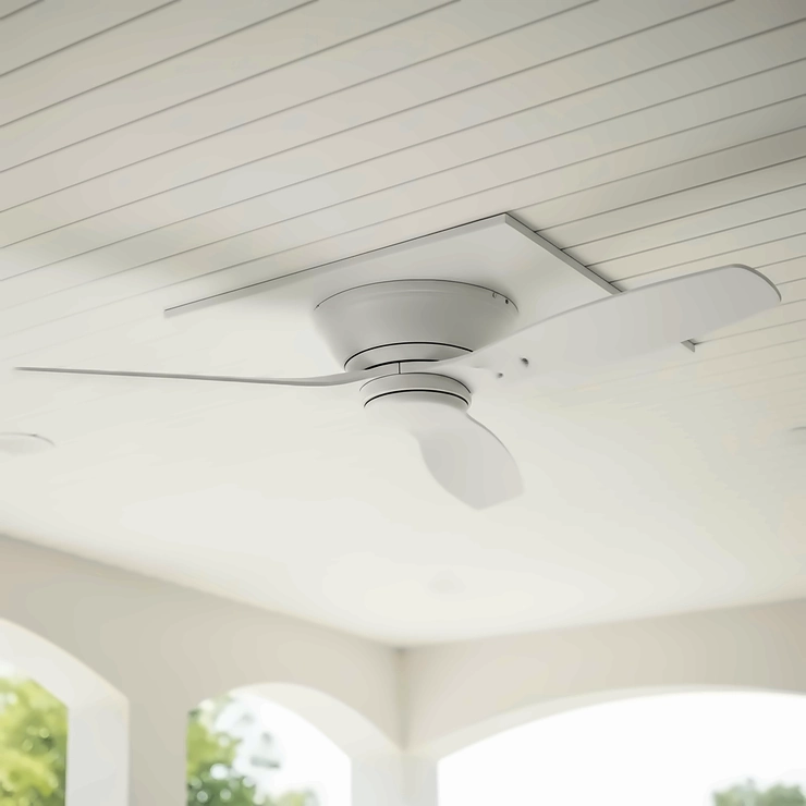 A white low profile outdoor ceiling fan with a flush mount installation, showing how it hugs the ceiling and is perfect for low-ceilinged sunrooms or patios.