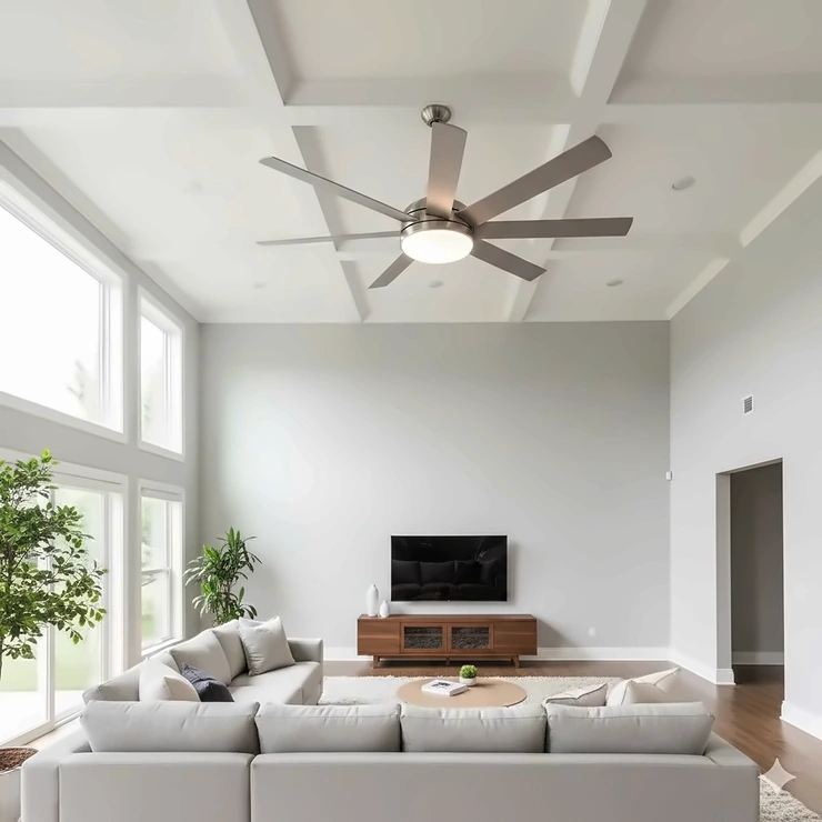 A large, modern 60 inch ceiling fan with light installed in a living room, featuring brushed nickel finish and LED light kit.