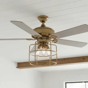 Close-up view of a farmhouse rustic ceiling fan with lights, showcasing light gray weathered wood blades and an antique brass finish.