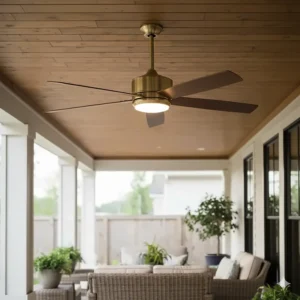 A large, damp-rated gold ceiling fan with long blades, suitable for use on an outdoor patio or covered deck area.
