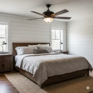 A rustic ceiling fan with dimmable LED lights installed in a cozy bedroom with shiplap walls and wood accents.