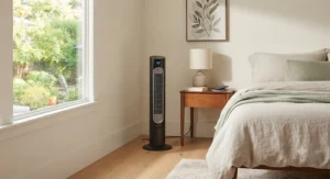 A slim, space-saving smart tower fan tucked into the corner of a bedroom.