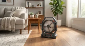 A rechargeable battery powered box fan placed on the floor of a modern living room.