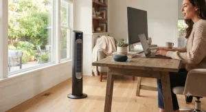 A smart tower fan compatible with voice assistants in a cozy home office setup.